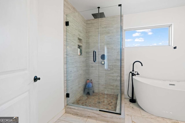 bathroom with separate shower and tub