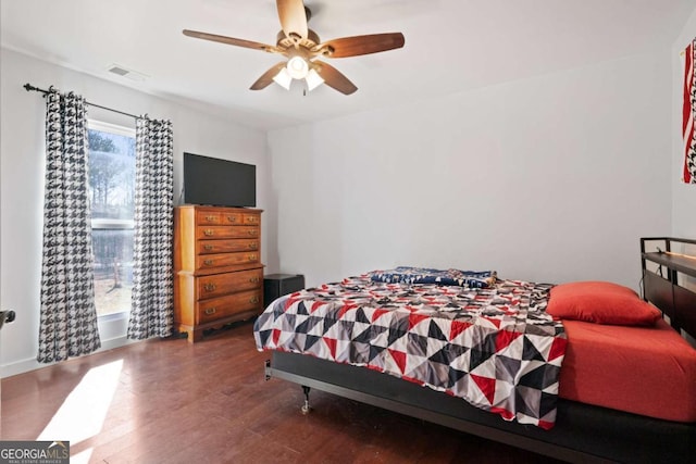 bedroom with dark wood-type flooring and ceiling fan