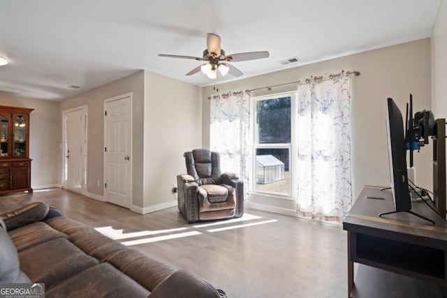 living room with hardwood / wood-style flooring and ceiling fan