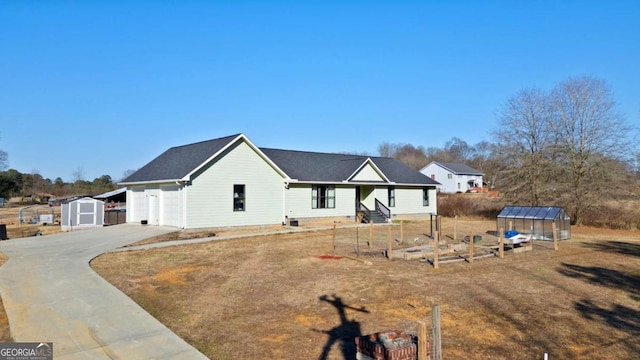 view of front of house with a storage unit and a garage