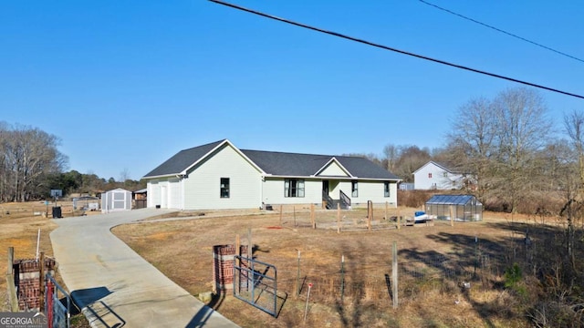 rear view of property featuring a shed