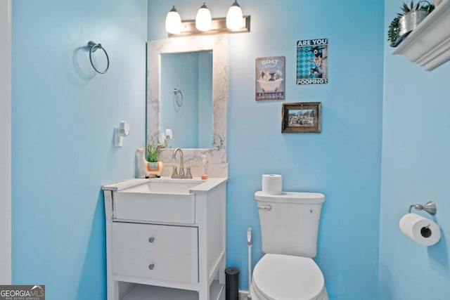 bathroom featuring vanity and toilet