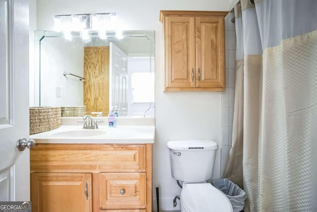 bathroom with vanity, toilet, and curtained shower