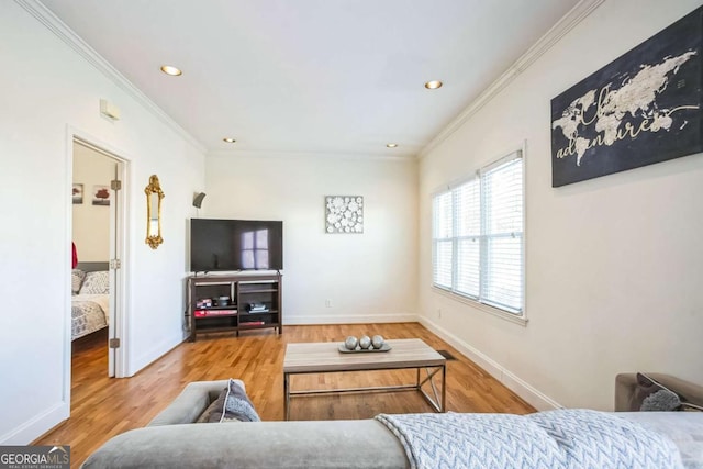 living room with hardwood / wood-style flooring and ornamental molding