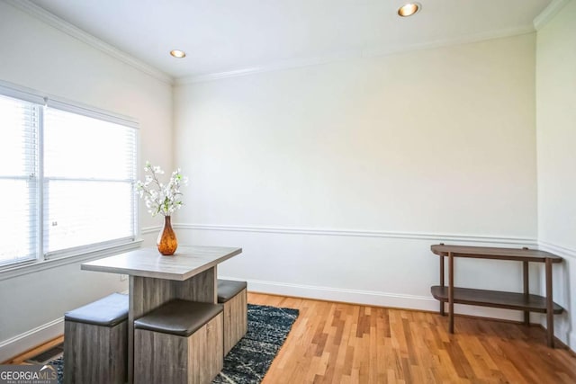 dining space featuring light hardwood / wood-style flooring and ornamental molding