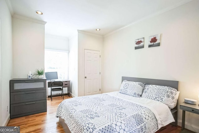 bedroom featuring hardwood / wood-style flooring and ornamental molding