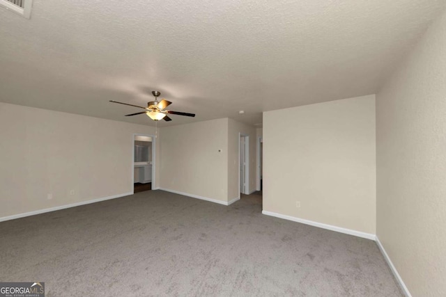 spare room with ceiling fan, carpet floors, and a textured ceiling