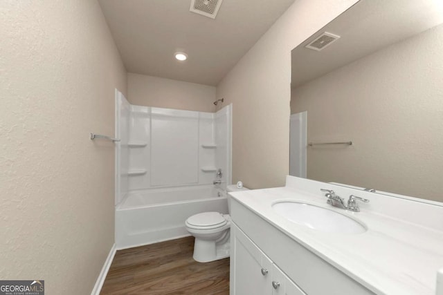 full bathroom with hardwood / wood-style flooring, vanity, toilet, and shower / bath combination