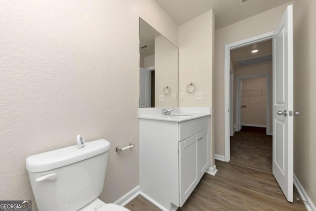 bathroom with vanity, hardwood / wood-style floors, and toilet