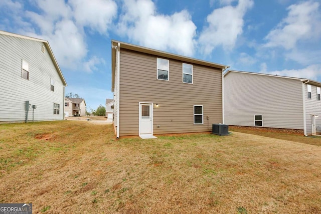 back of property featuring cooling unit and a lawn