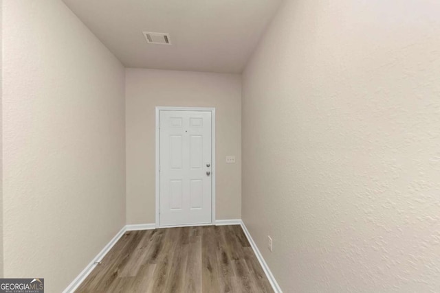 corridor with wood-type flooring