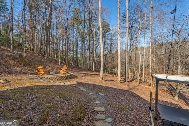 view of yard featuring an outdoor fire pit