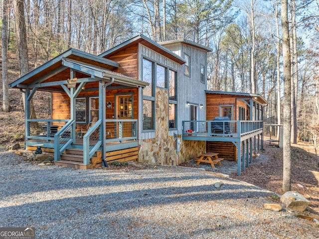 view of front of home with a porch and a wooden deck