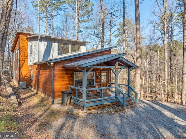 view of front of property with cooling unit and covered porch