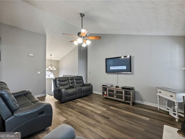 living room featuring vaulted ceiling, dark wood-type flooring, and ceiling fan with notable chandelier