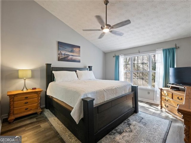 bedroom featuring lofted ceiling, ceiling fan, dark hardwood / wood-style flooring, and a textured ceiling