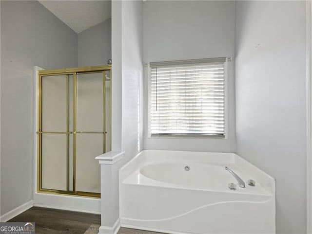 bathroom with hardwood / wood-style flooring and separate shower and tub