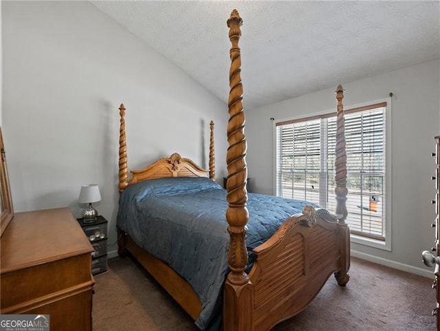 bedroom featuring lofted ceiling, a textured ceiling, and dark carpet