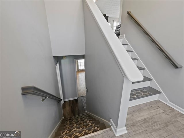 stairs with hardwood / wood-style floors