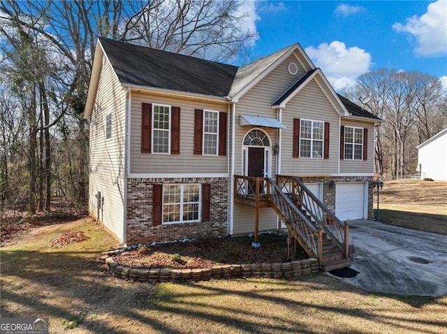 bi-level home with a garage and a front yard