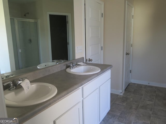 bathroom featuring an enclosed shower and vanity