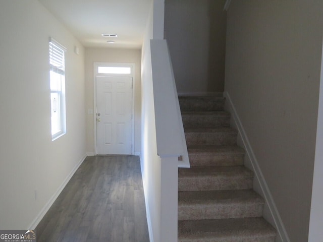 stairs featuring hardwood / wood-style flooring