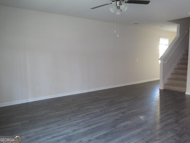 empty room with ceiling fan and dark hardwood / wood-style flooring