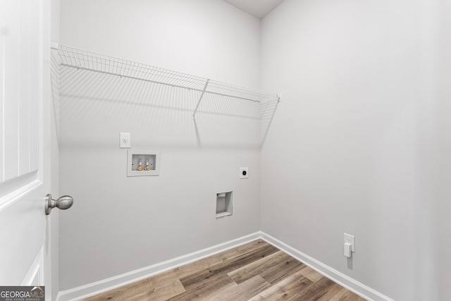 clothes washing area featuring hardwood / wood-style floors, electric dryer hookup, and washer hookup