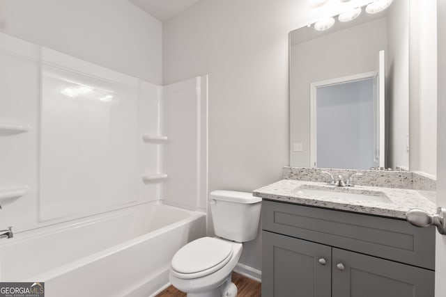 full bathroom featuring vanity, toilet, wood-type flooring, and shower / bathing tub combination