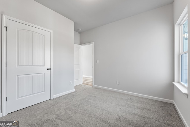 spare room featuring light carpet