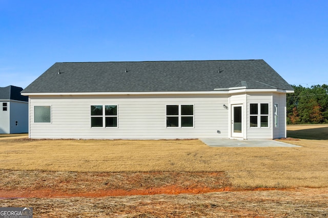 back of property featuring a yard and a patio area