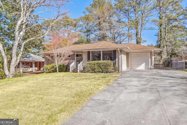 ranch-style house with a garage and a front lawn