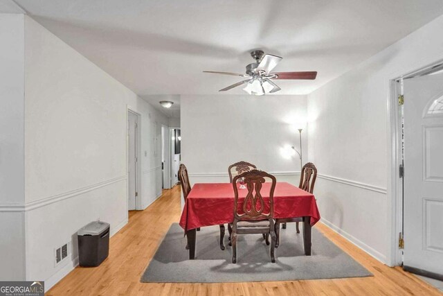 dining area with ceiling fan and light hardwood / wood-style floors