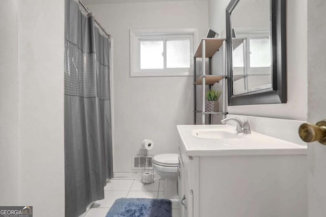 bathroom featuring vanity, a shower with shower curtain, tile patterned floors, and toilet