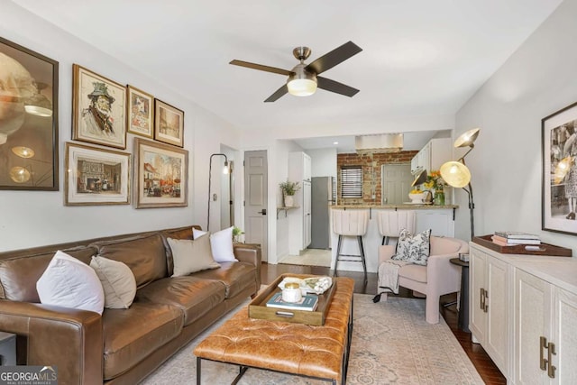 living room with ceiling fan and light wood-type flooring