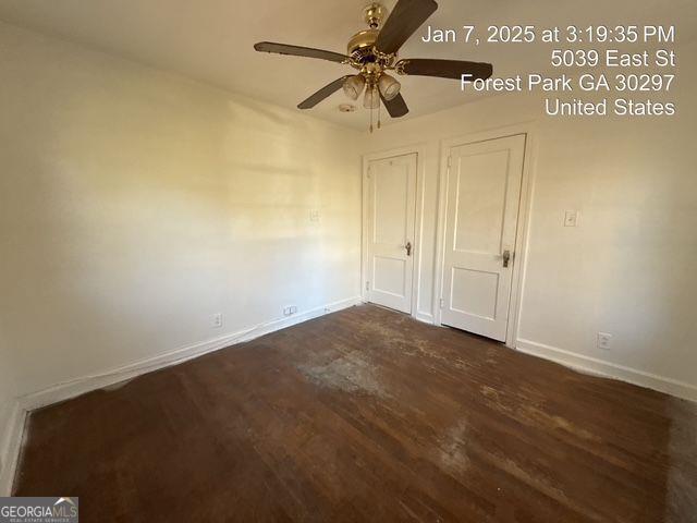 unfurnished bedroom featuring ceiling fan and dark hardwood / wood-style floors