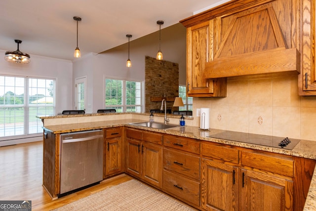 kitchen with dishwasher, sink, black electric stovetop, and kitchen peninsula