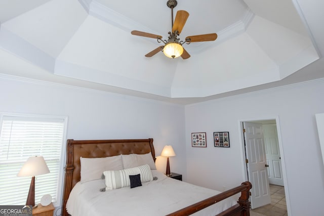 bedroom featuring crown molding, a raised ceiling, and ceiling fan