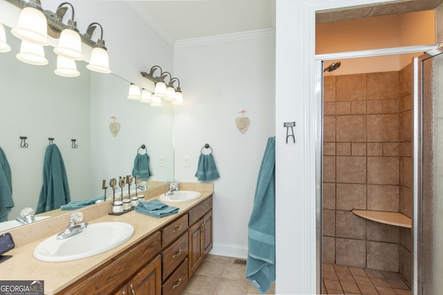 bathroom with vanity, tile patterned floors, ornamental molding, and a tile shower