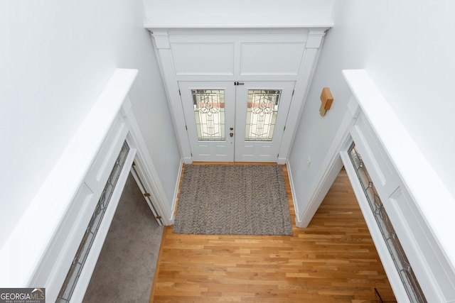 foyer entrance with french doors and light wood-type flooring