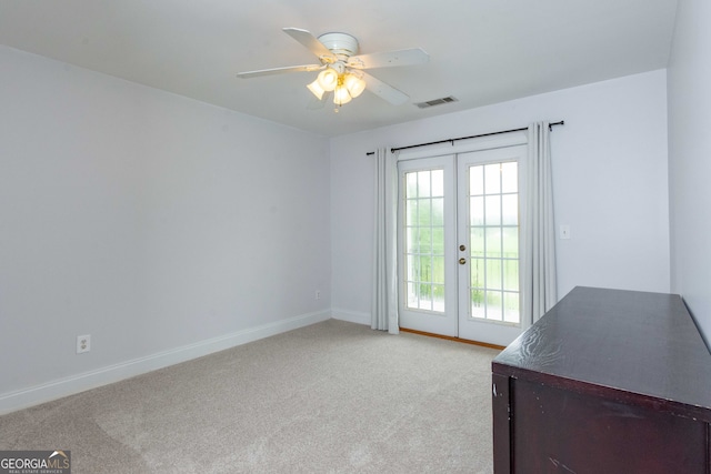 doorway to outside featuring light carpet, french doors, and ceiling fan