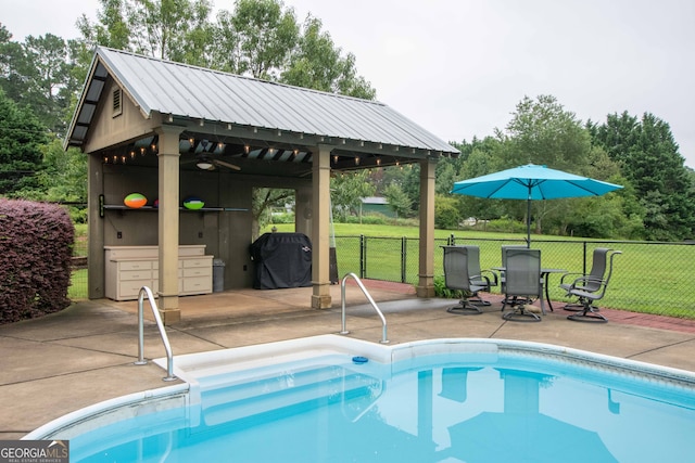 view of swimming pool featuring a yard, grilling area, a patio, and a gazebo