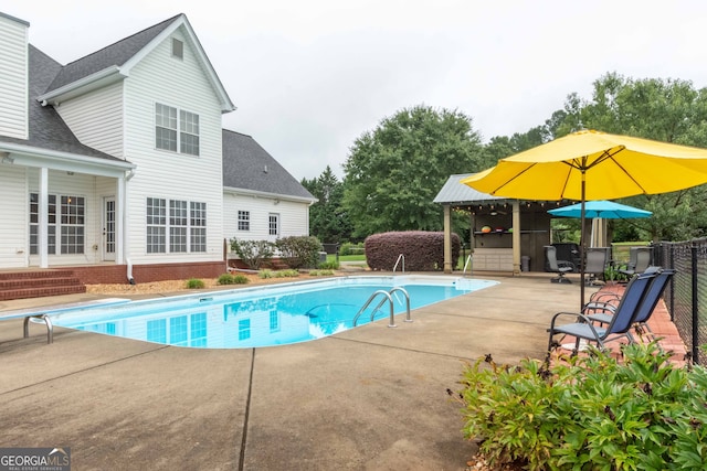 view of pool with a gazebo, a diving board, and a patio