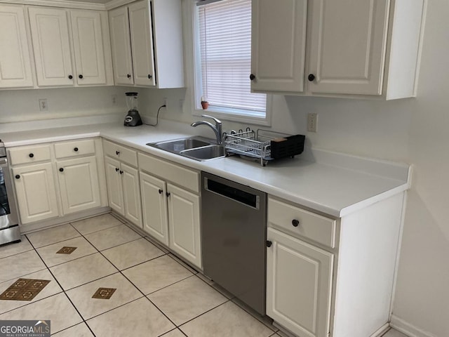 kitchen with white cabinetry, sink, light tile patterned floors, and dishwasher