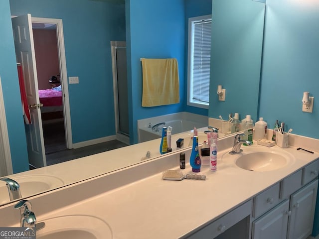 bathroom featuring vanity and separate shower and tub