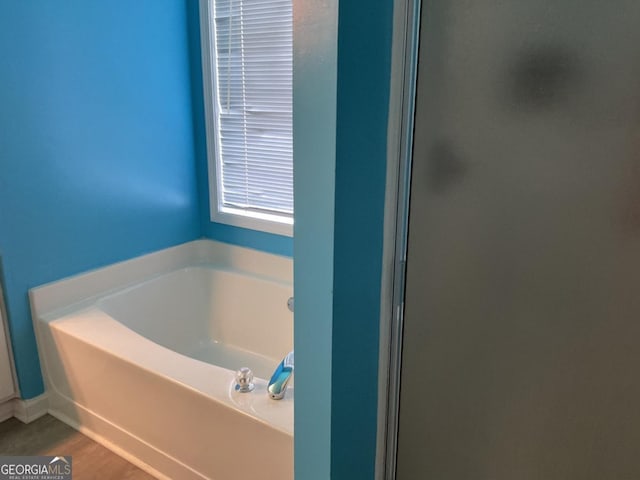 bathroom with a tub to relax in