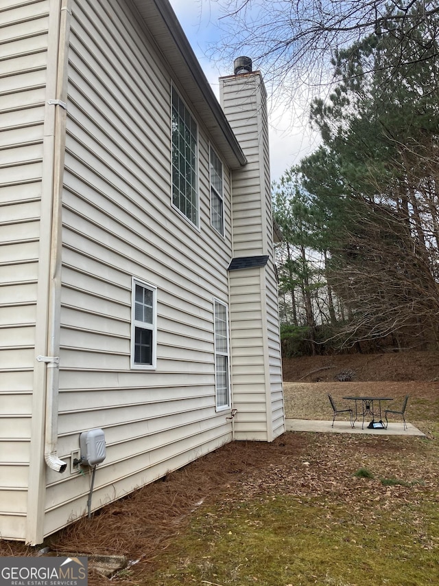 view of property exterior with a patio area