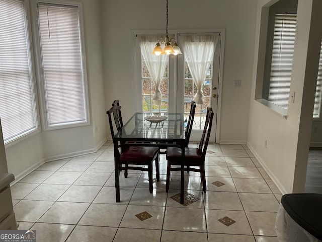 dining space featuring an inviting chandelier and light tile patterned flooring