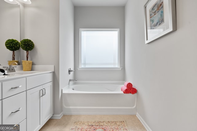 bathroom featuring vanity, tile patterned floors, and a tub