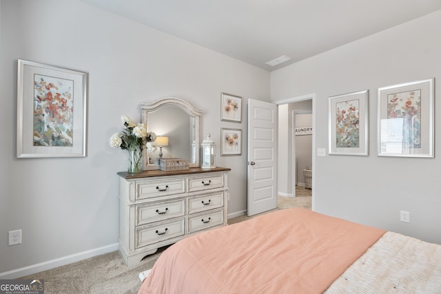 bedroom featuring light colored carpet